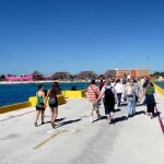 travellers get out to explore the port of call on their cruise vacation