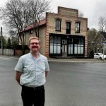 Nick Kulnies Standing before the Cafe Tropical in Schitt's Creek